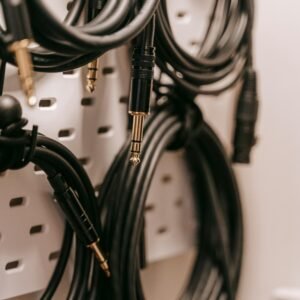 Close-up of audio cables on a pegboard for organized storage.